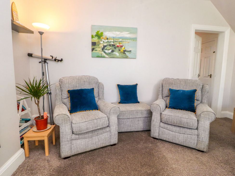 A living room featuring chairs and a lamp at Lytham House in Lytham St. Annes