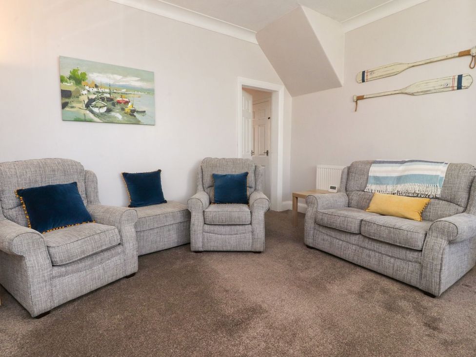 A living room with sofas and a painting at Lytham House Lytham St. Annes