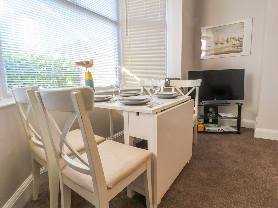 A dining table set with plates and glasses at Lytham House in Lytham St. Annes