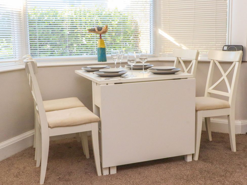 A dining area with a table and chairs at Lytham House in Lytham St. Annes