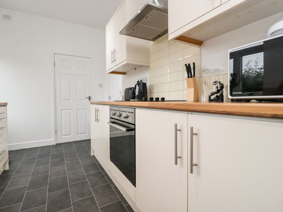 A kitchen with appliances and cabinets at Lytham House in Lytham St. Annes