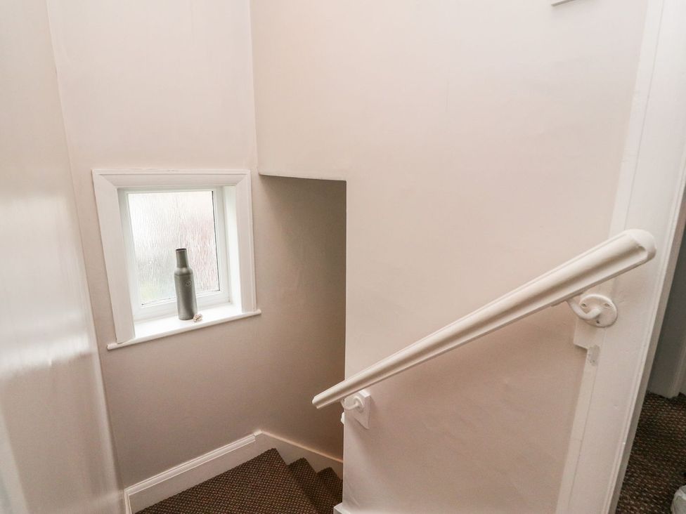 A staircase with a window and a bottle at Lytham House in Lytham St. Annes