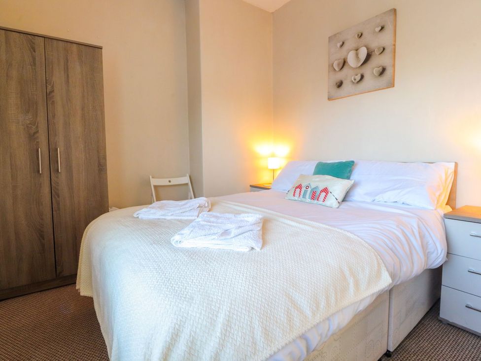A bedroom with a bed and wardrobe at Lytham House in Lytham St. Annes