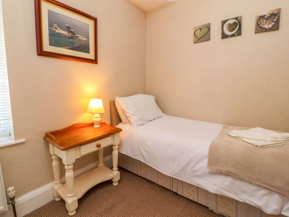 A bedroom with a bed and a lamp at Lytham House Lytham St. Annes