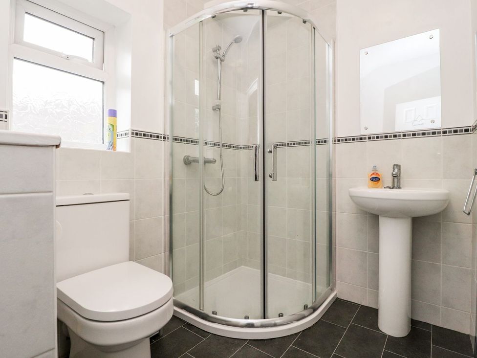 A bathroom with a shower, toilet, and sink at Lytham House in Lytham St. Annes