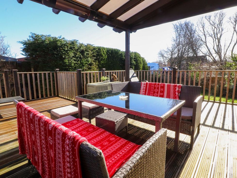 A patio with outdoor furniture and a table at Lytham House in Lytham St. Annes