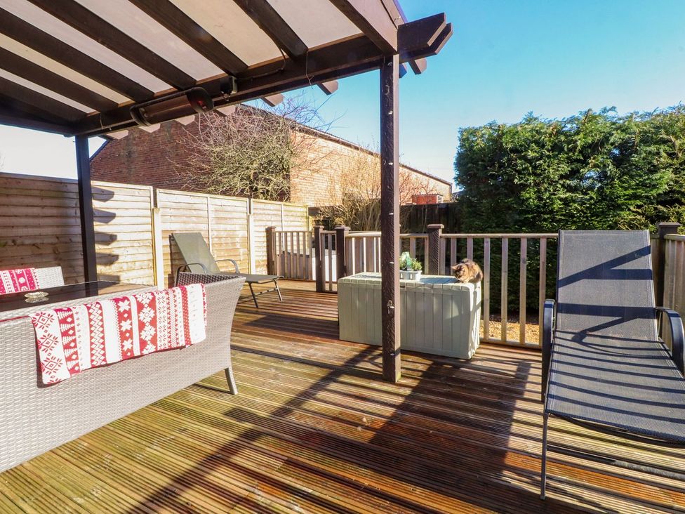 An outdoor seating area with a table and chairs at Lytham House in Lytham St. Annes
