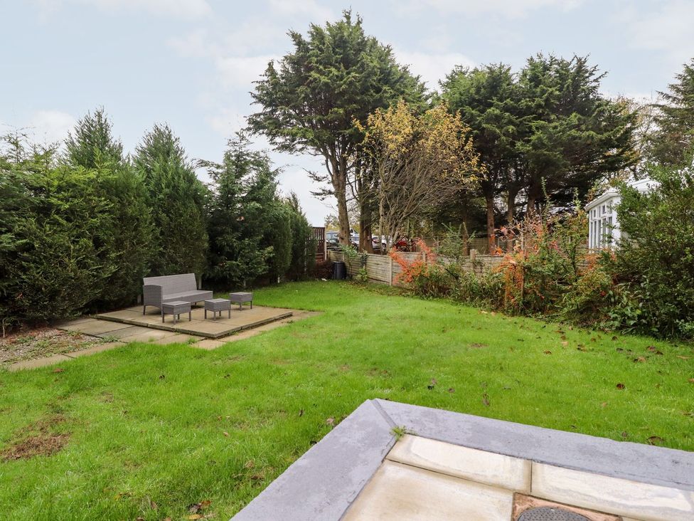 A garden with a seating area and trees at Lytham House in Lytham St. Annes