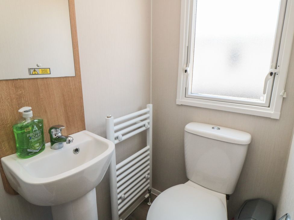 A bathroom with a sink and toilet at 14 Pines in Cayton Bay