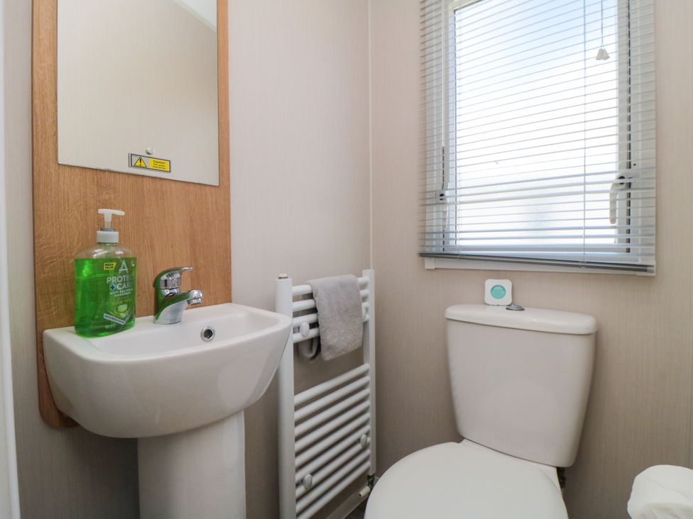 A bathroom with a sink and toilet at 14 Pines in Cayton Bay