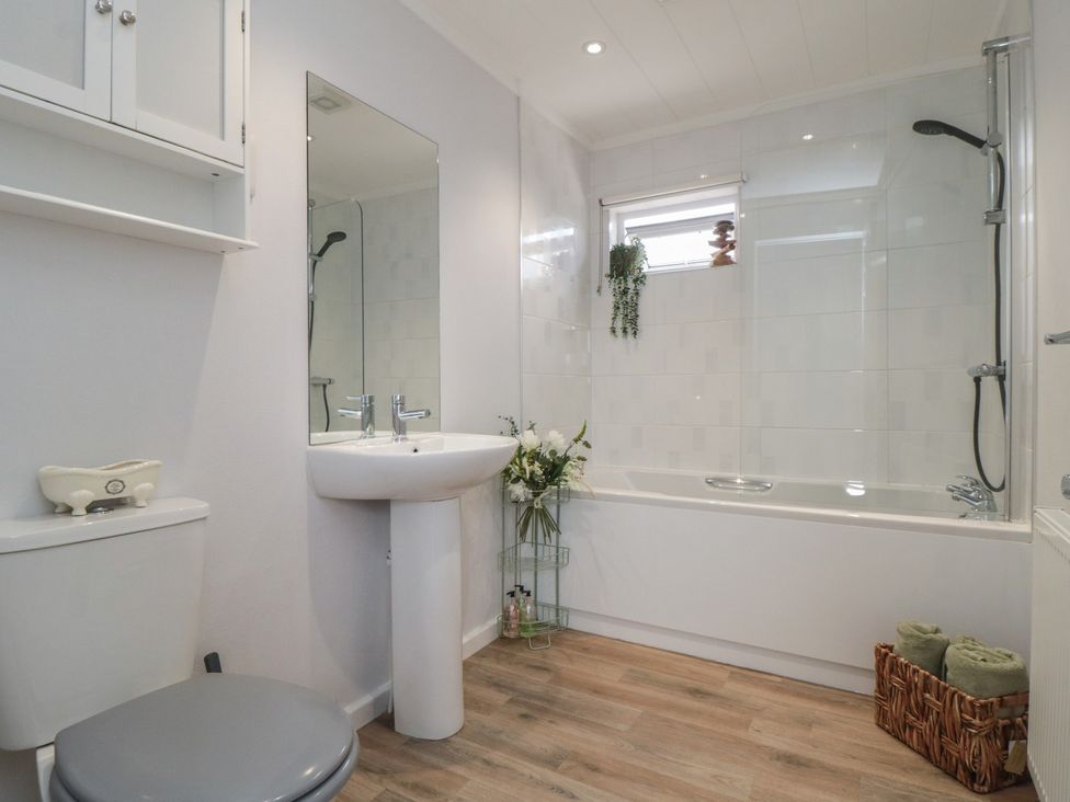 A bathroom with a bathtub and sink at Sea Glass Lodge in Saltburn-by-the-Sea