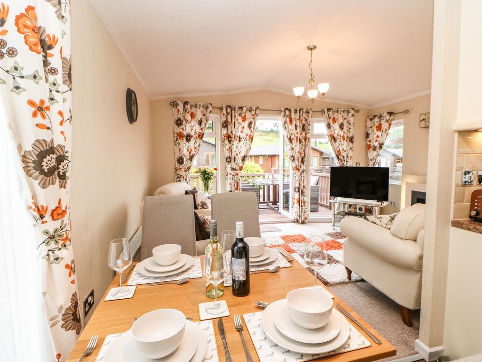 A dining room with a table set for dinner at 10 Poppy Lodge in Richmond