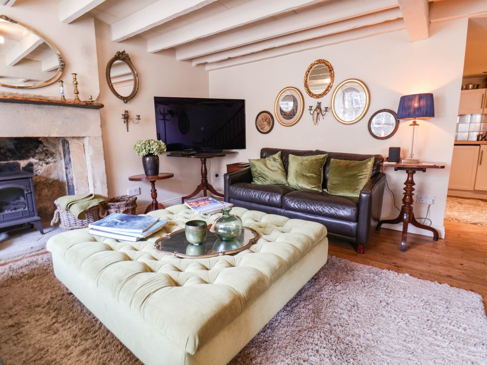 A living room with a sofa, coffee table, and television at bellebeck