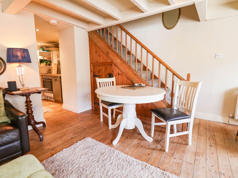 A dining area with a table and chairs at bellebeck