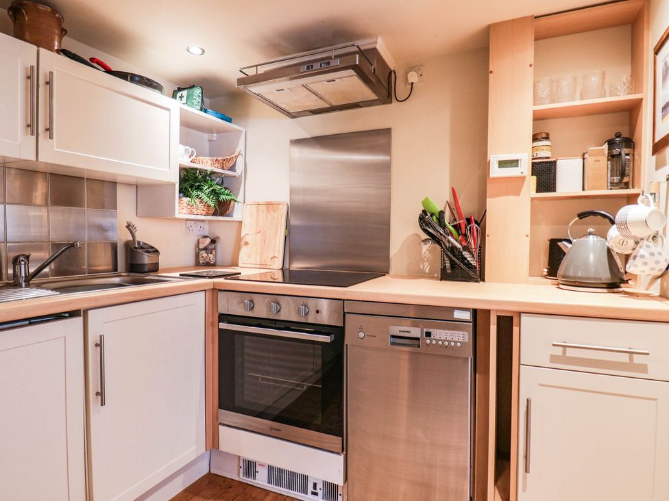 A kitchen with a sink, oven, and dishwasher at bellebeck