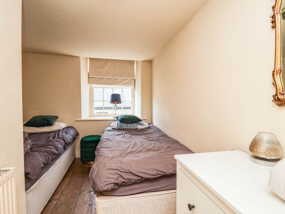 A bedroom with two beds and a lamp at bellebeck