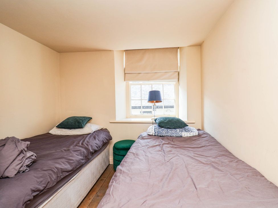 A bedroom with two beds and a lamp at bellebeck