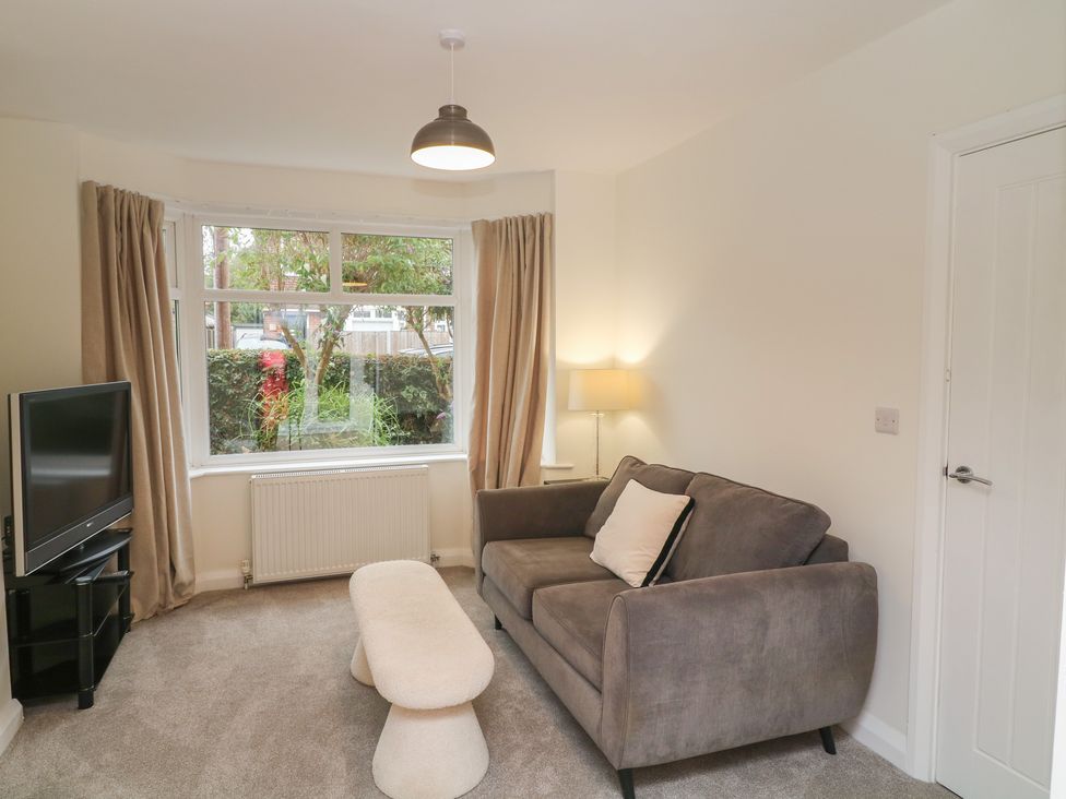 A living room with a sofa and television at No.40 Rufford Road in Ruddington