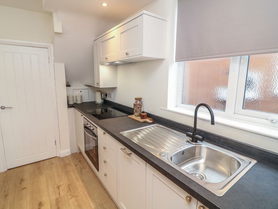 A kitchen with an oven and sink at No.40 Rufford Road in Ruddington