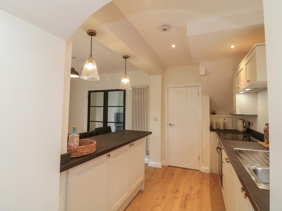 A kitchen with a countertop and stools at No.40 Rufford Road in Ruddington