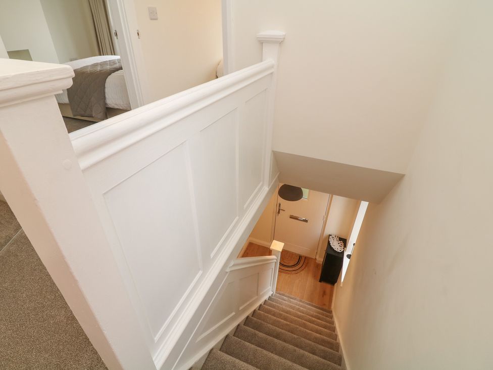 A staircase with a handrail and door at No.40 Rufford Road in Ruddington