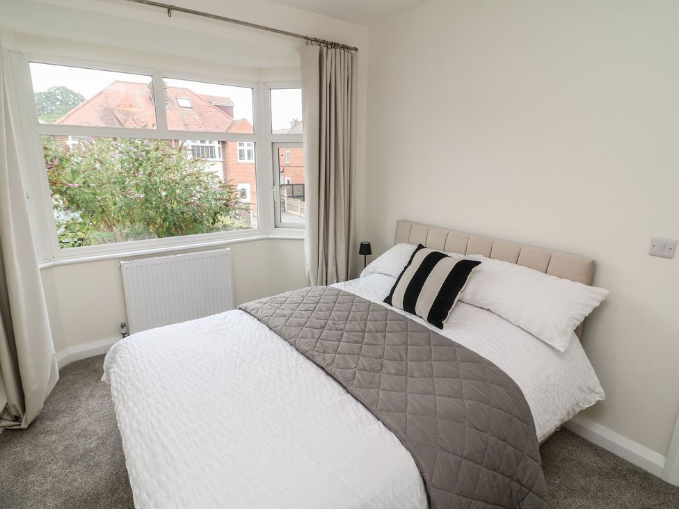 A bedroom with a bed and windows at No.40 Rufford Road in Ruddington