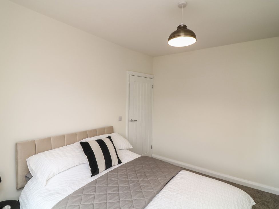 A bedroom with a bed and door at No.40 Rufford Road Ruddington
