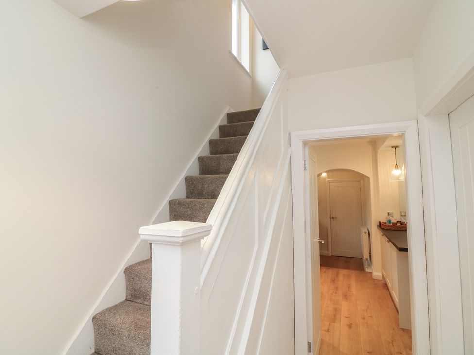 A hallway with a staircase and a door leading to another room at No.40 Rufford Road Ruddington