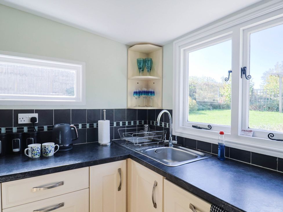 A kitchen with a sink and kettle at Farthing Cottage in Corfe Castle