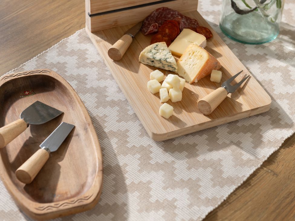 A cheese platter with various cheeses and cured meats at Hambledon Hill Cottage in Blandford Forum