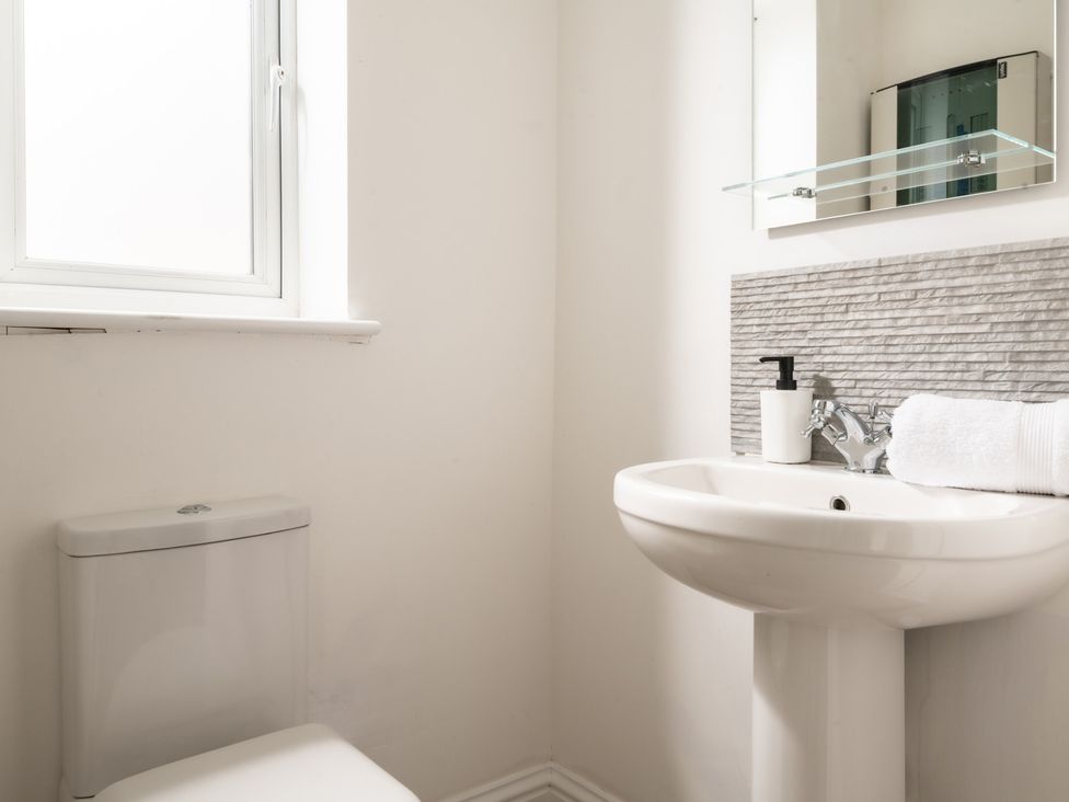 A bathroom with a sink and toilet at Hambledon Hill Cottage in Blandford Forum