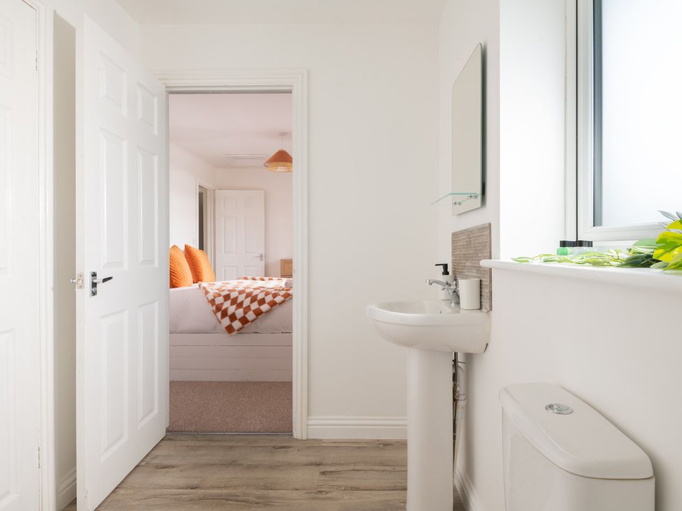 A bathroom with sink and toilet at Hambledon Hill Cottage in Blandford Forum