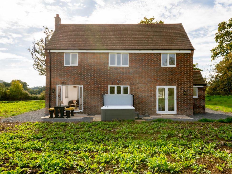 A house with a patio and hot tub at Hambledon Hill Cottage Blandford Forum
