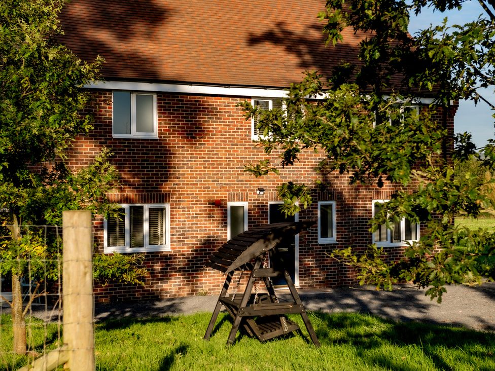 A brick house with windows and a door at Hambledon Hill Cottage Blandford Forum