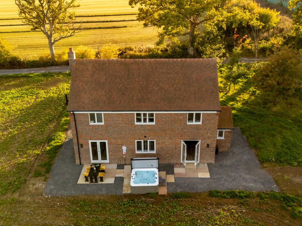 A house with a hot tub and outdoor seating at Hambledon Hill Cottage Blandford Forum