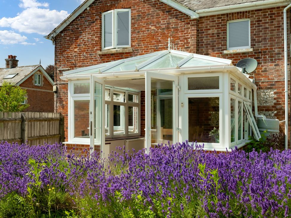 A conservatory surrounded by lavender at Charming Countryside Cottage in Blandford Forum