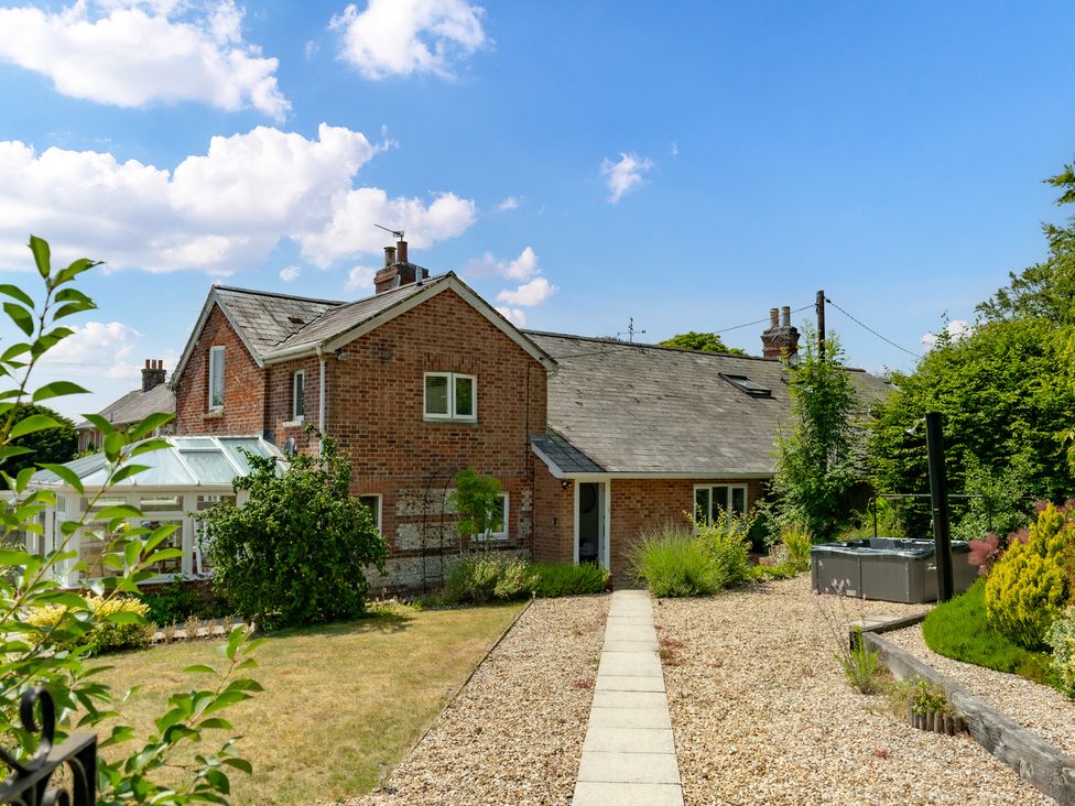 An outdoor view of a house and garden at Charming Countryside Cottage in Blandford Forum