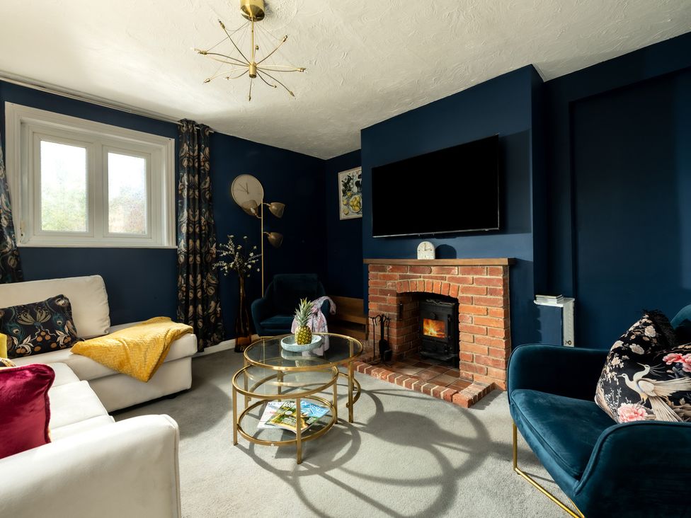 A living room with a sofa and coffee table at Charming Countryside Cottage in Blandford Forum