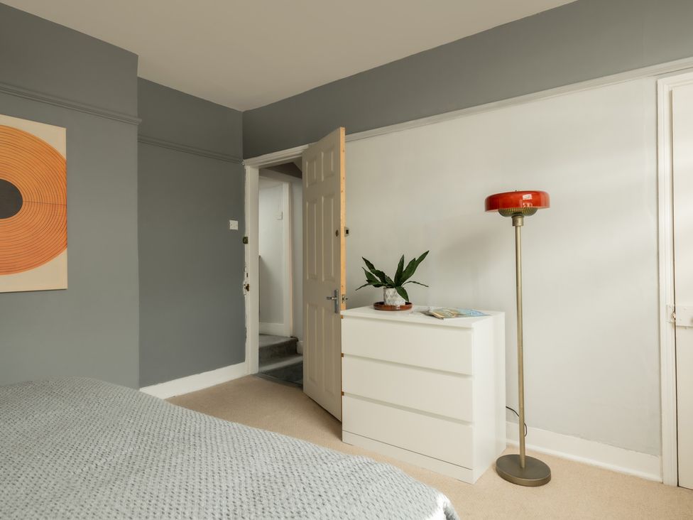 A bedroom with a bed and chest of drawers at Charming Countryside Cottage in Blandford Forum