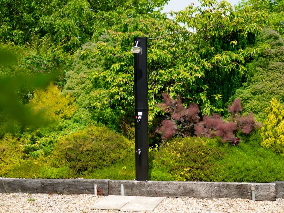 An outdoor shower in a garden at Charming Countryside Cottage in Blandford Forum