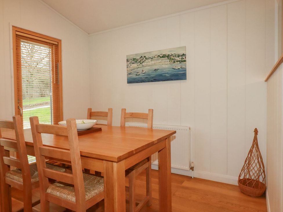 A dining room with a table and chairs at 1 Water's Edge