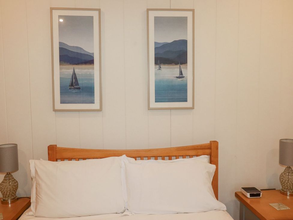 A bedroom with artwork on the wall at 1 Water's Edge