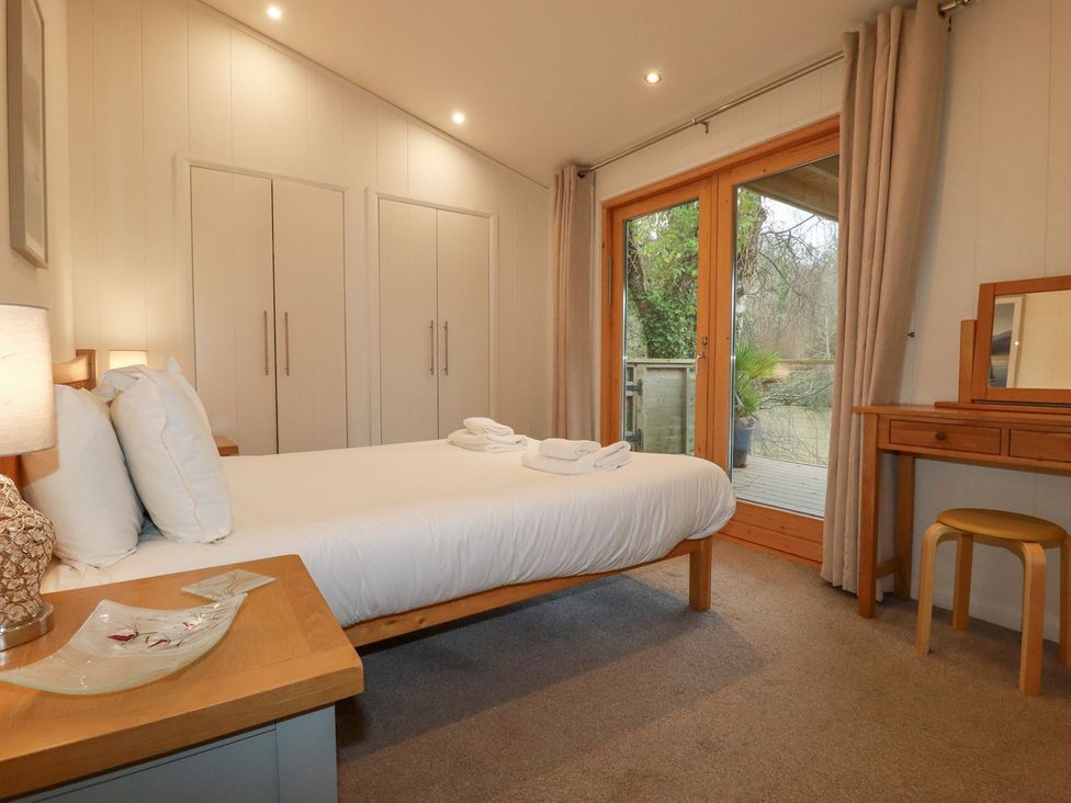 A bedroom with a bed and dresser at 1 Water's Edge 