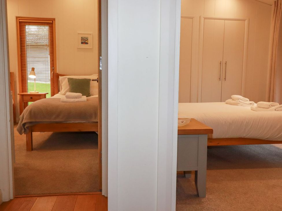 A bedroom with two beds and a window at 1 Water's Edge
