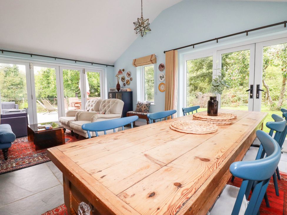 A dining room with a large wooden table and chairs at The Homestead 