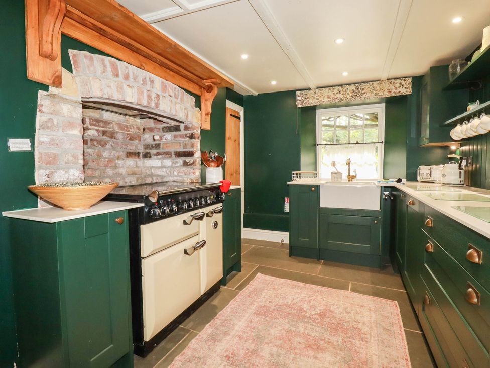 A kitchen with stove and sink at The Homestead 
