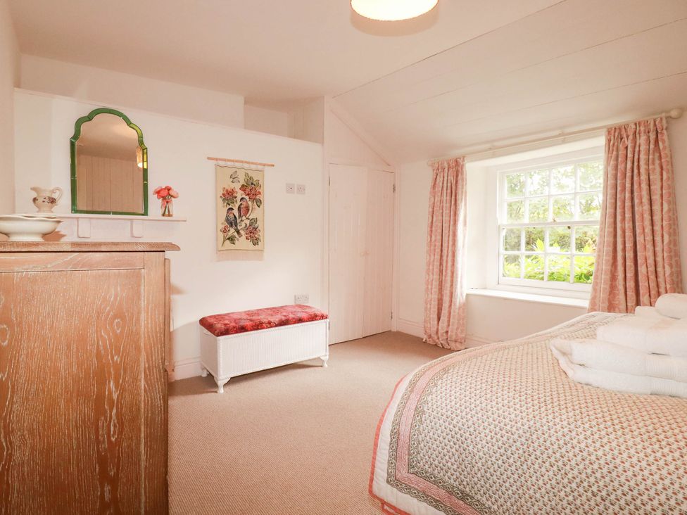 A bedroom with a bed and window at The Homestead 