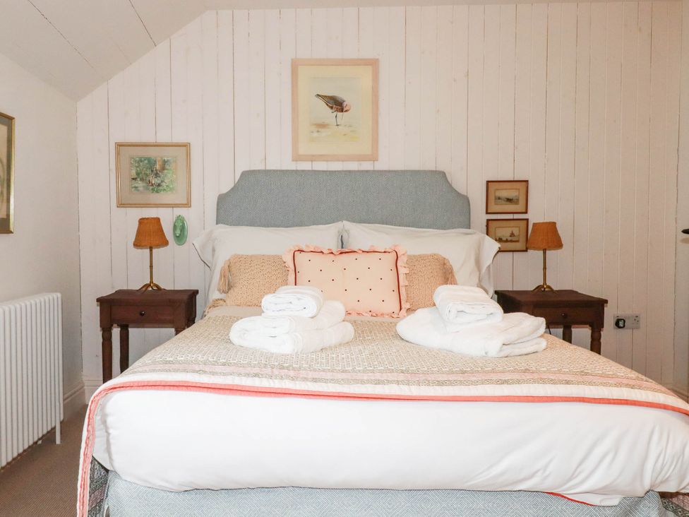A bedroom with a bed and nightstands at The Homestead 