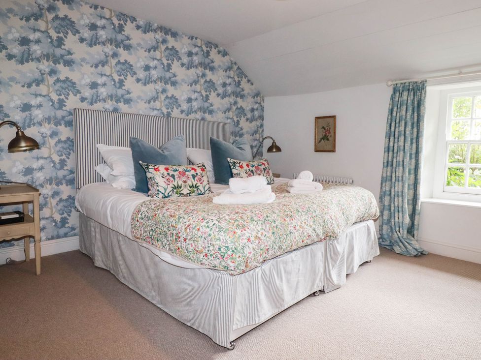 A bedroom with a double bed and a nightstand at The Homestead 