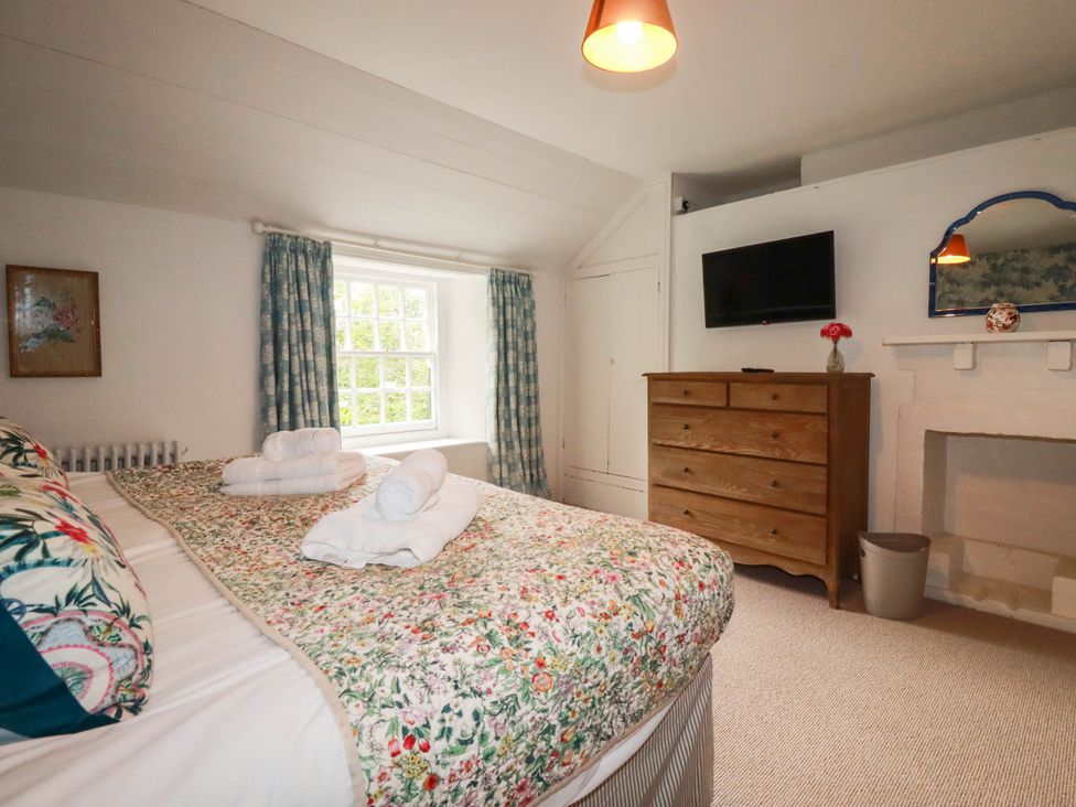 A bedroom with a bed and television at The Homestead